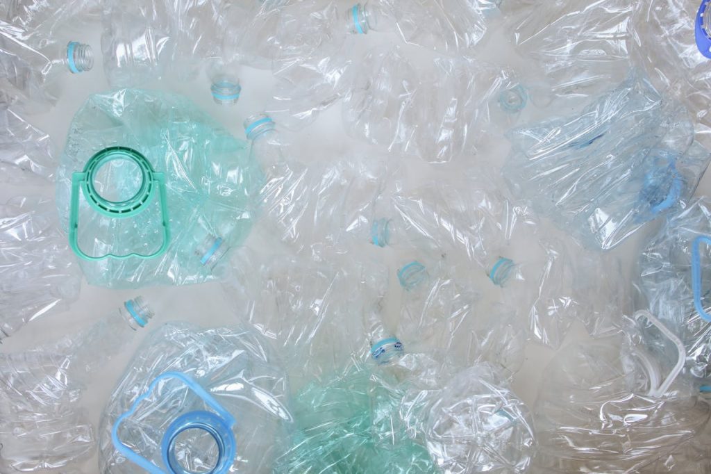 plastic-bottles-3735205 Top-view of crushed plastic bottles prepared for recycling, promoting sustainability.